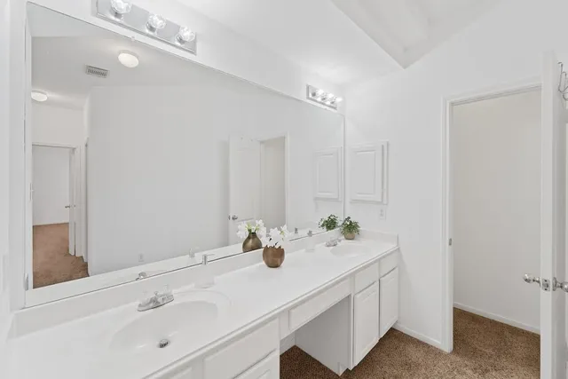 a bathroom with a sink vanity and mirror