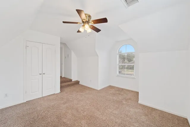 a view of a livingroom with a ceiling fan and window