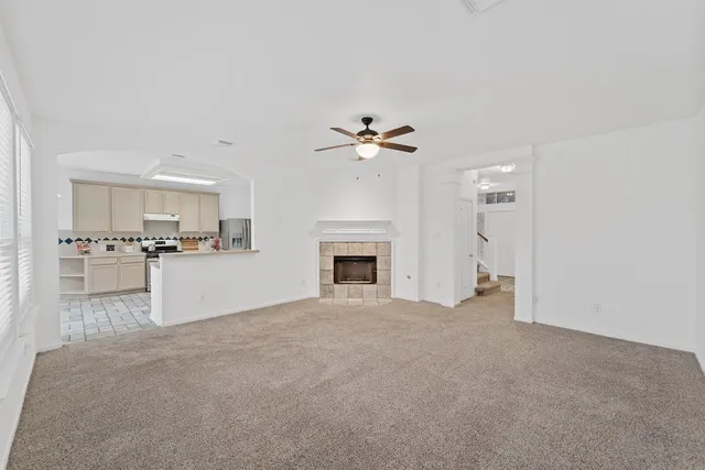 a view of an empty room with a kitchen