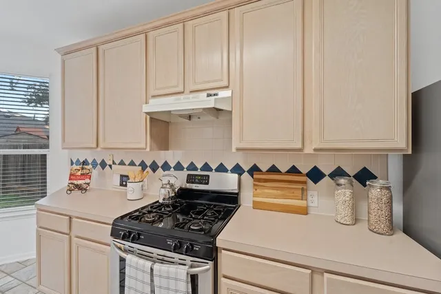 a kitchen with a stove and a cabinet