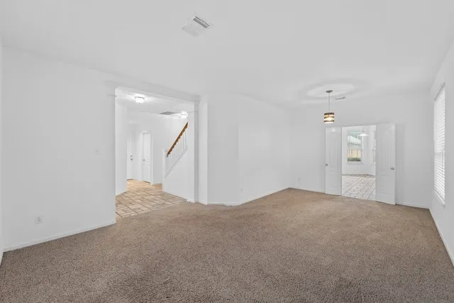 a view of a big room with closet and windows