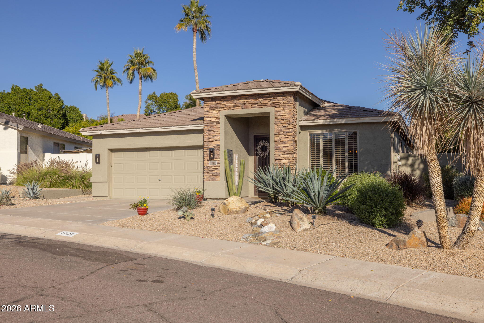 1622 West Nighthawk Way Phoenix, AZ 85045 - Photo 11 of 70 a front view of a house with a yard