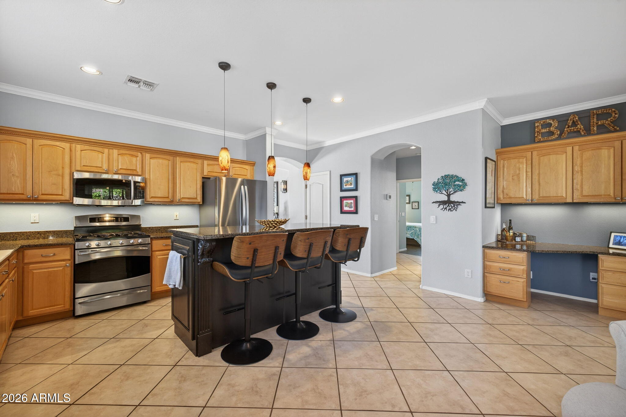 1622 West Nighthawk Way Phoenix, AZ 85045 - Photo 19 of 70 a kitchen with stainless steel appliances kitchen island granite countertop a stove refrigerator sink and cabinets