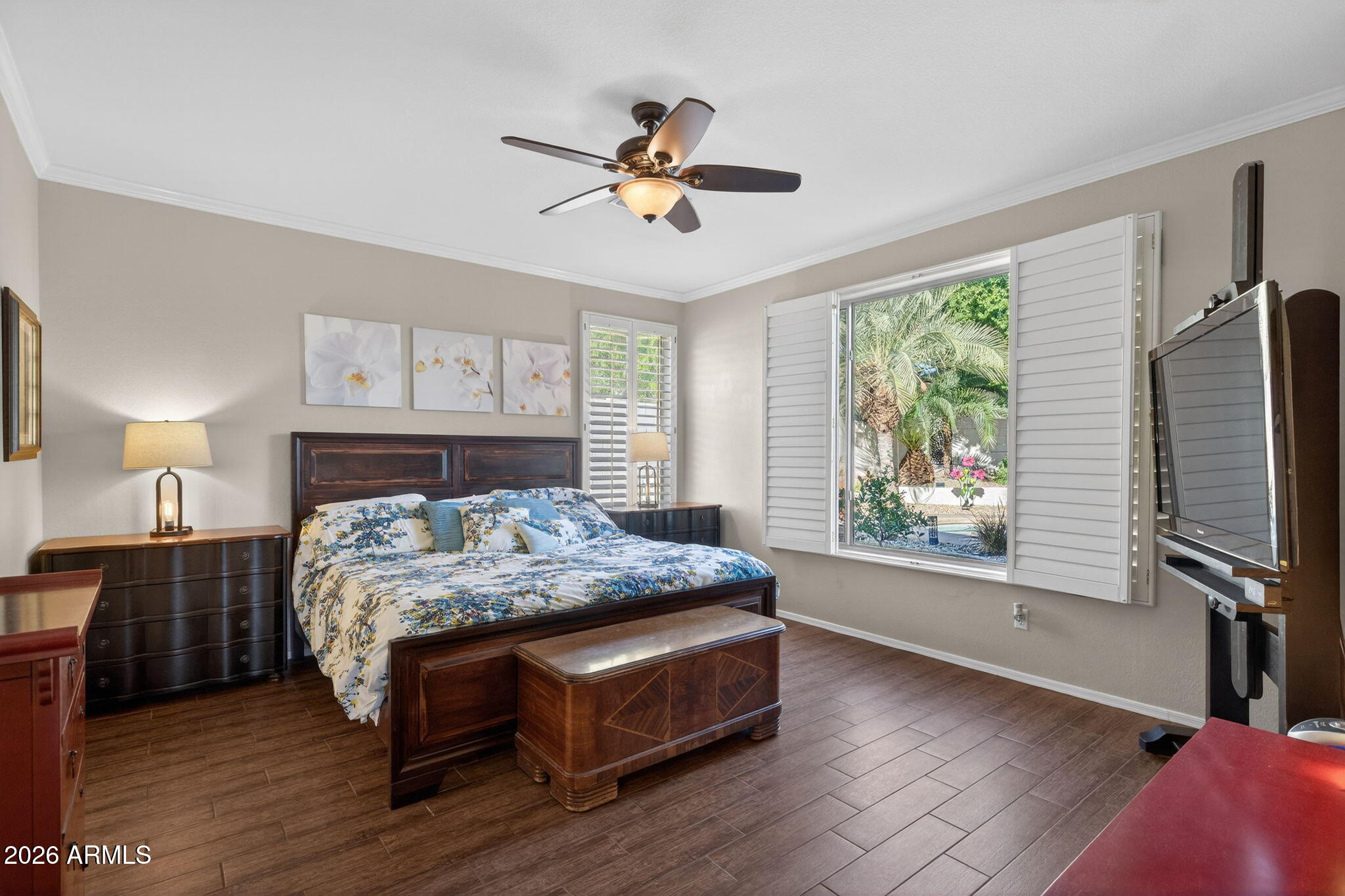 1622 West Nighthawk Way Phoenix, AZ 85045 - Photo 32 of 70 a bedroom with a bed and a flat tv screen on dresser