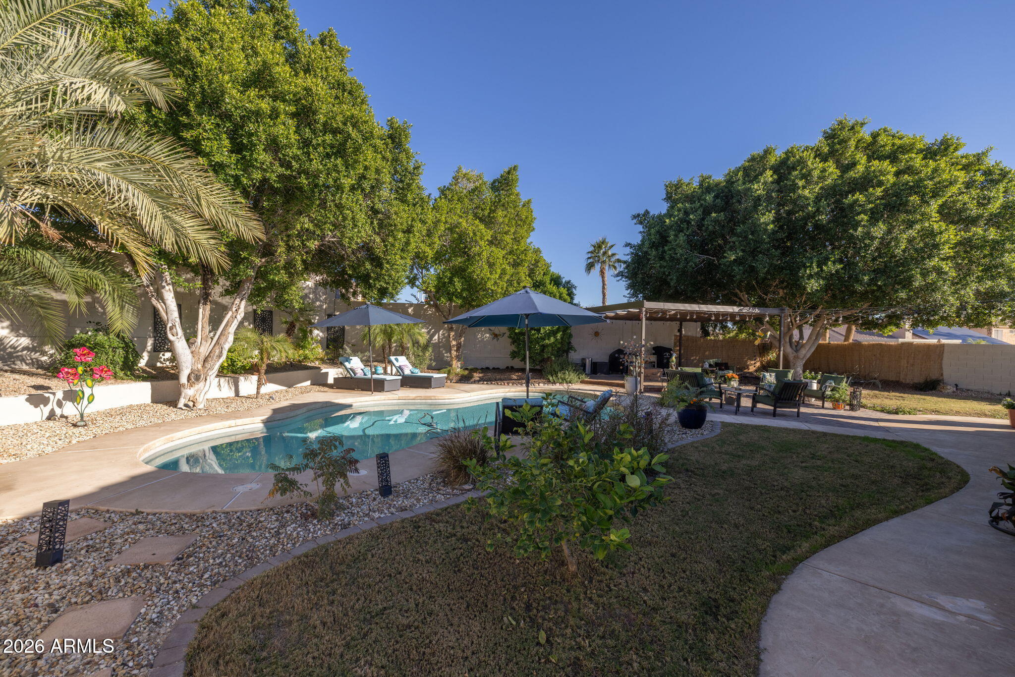 1622 West Nighthawk Way Phoenix, AZ 85045 - Photo 40 of 70 a view of backyard with table and chairs and potted plants
