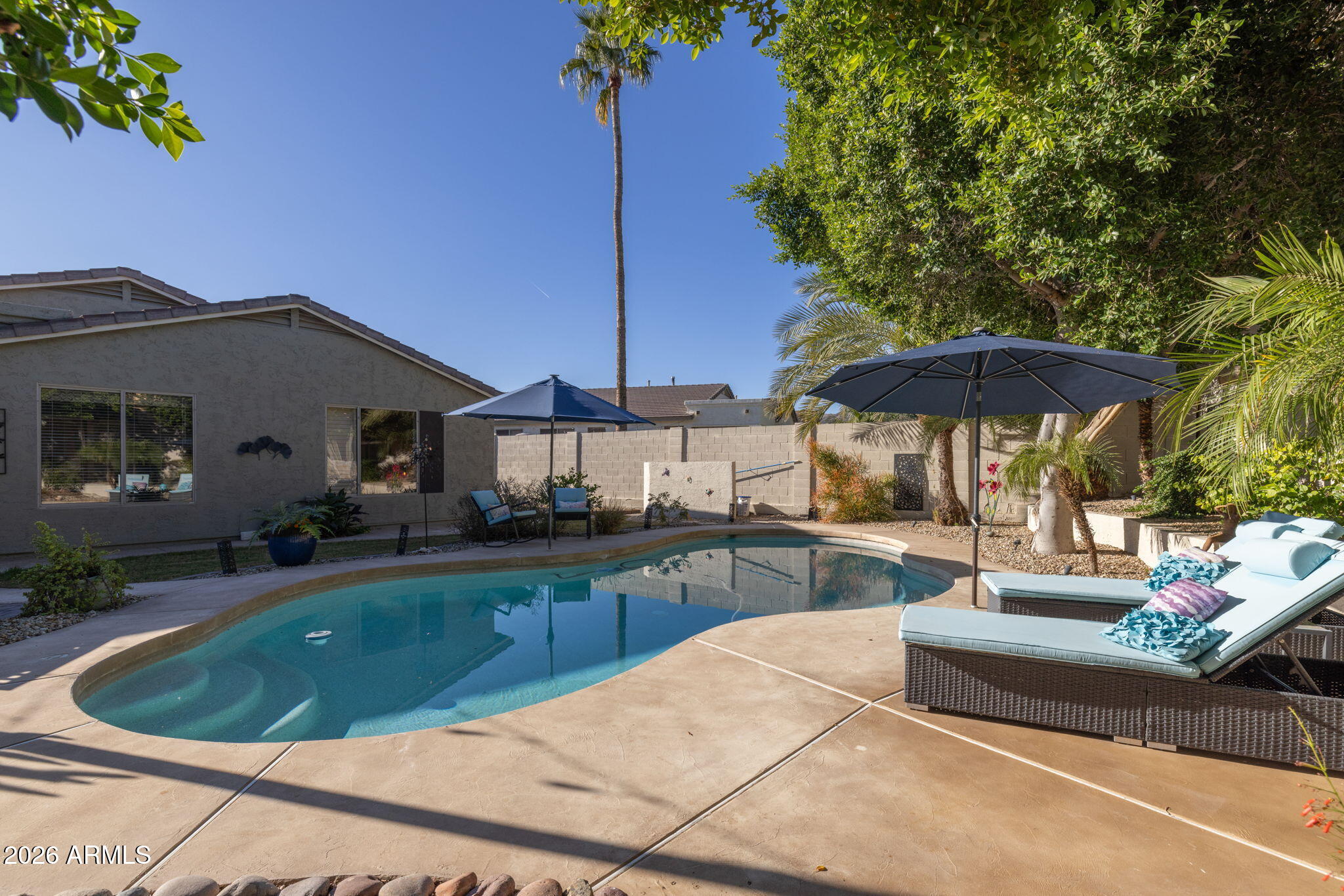 1622 West Nighthawk Way Phoenix, AZ 85045 - Photo 5 of 70 a view of a house with backyard outdoor seating area and furniture