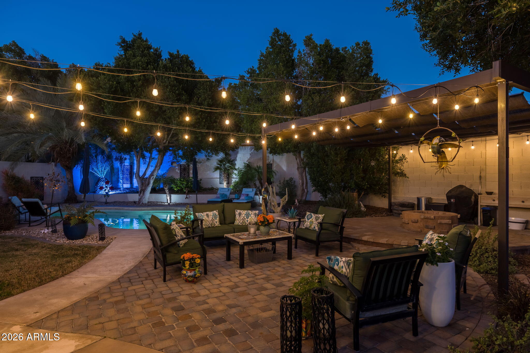 1622 West Nighthawk Way Phoenix, AZ 85045 - Photo 56 of 70 a view of a patio with dining table and chairs with plants and a barbeque