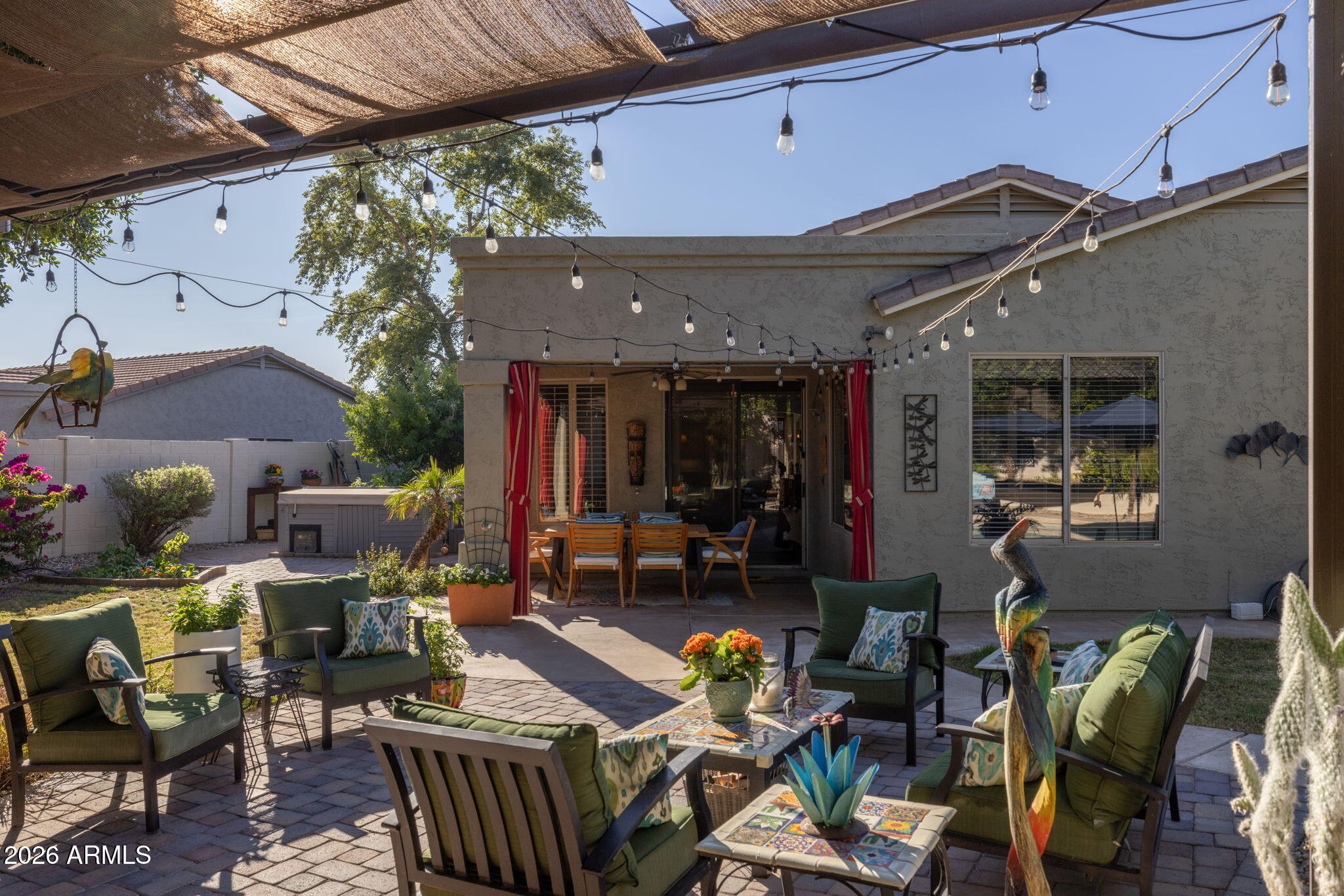 1622 West Nighthawk Way Phoenix, AZ 85045 - Photo 6 of 70 a view of a patio with dining table and chairs under an umbrella