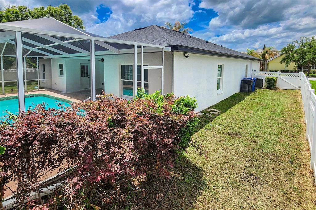 7027 Frascati Loop Wesley Chapel, FL 33544 - Photo 26 of 28 a view of a house with a garden and plants