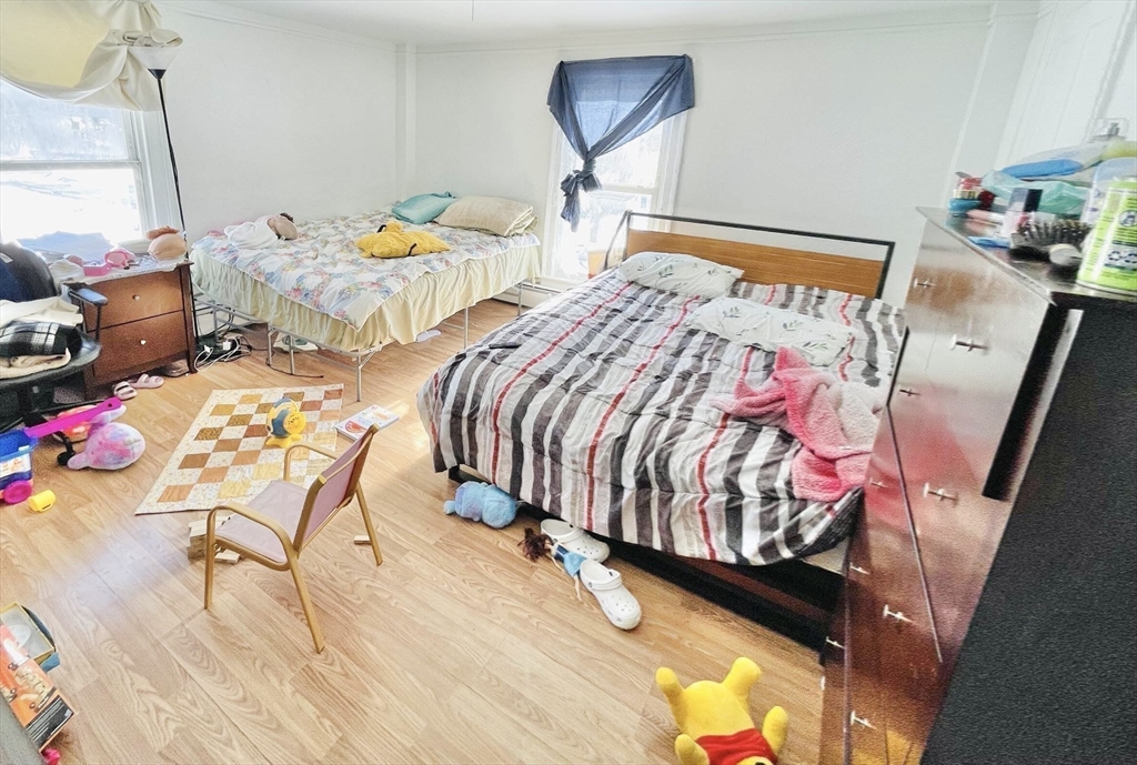 92 Mill Street Lancaster, MA 01523 - Photo 14 of 26 a bedroom with two beds next to a window