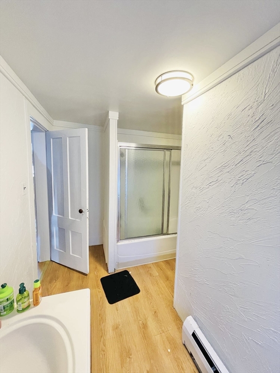 92 Mill Street Lancaster, MA 01523 - Photo 15 of 26 a bedroom with a bed and a chandelier