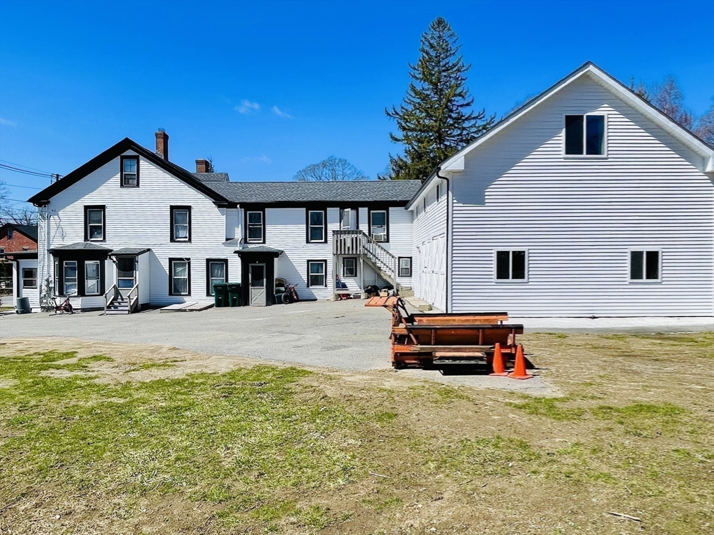 92 Mill Street Lancaster, MA 01523 - Photo 16 of 26 a front view of a house with a yard