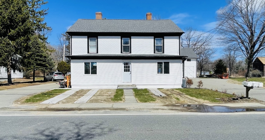 92 Mill Street Lancaster, MA 01523 - Photo 26 of 26 a front view of a house with a yard