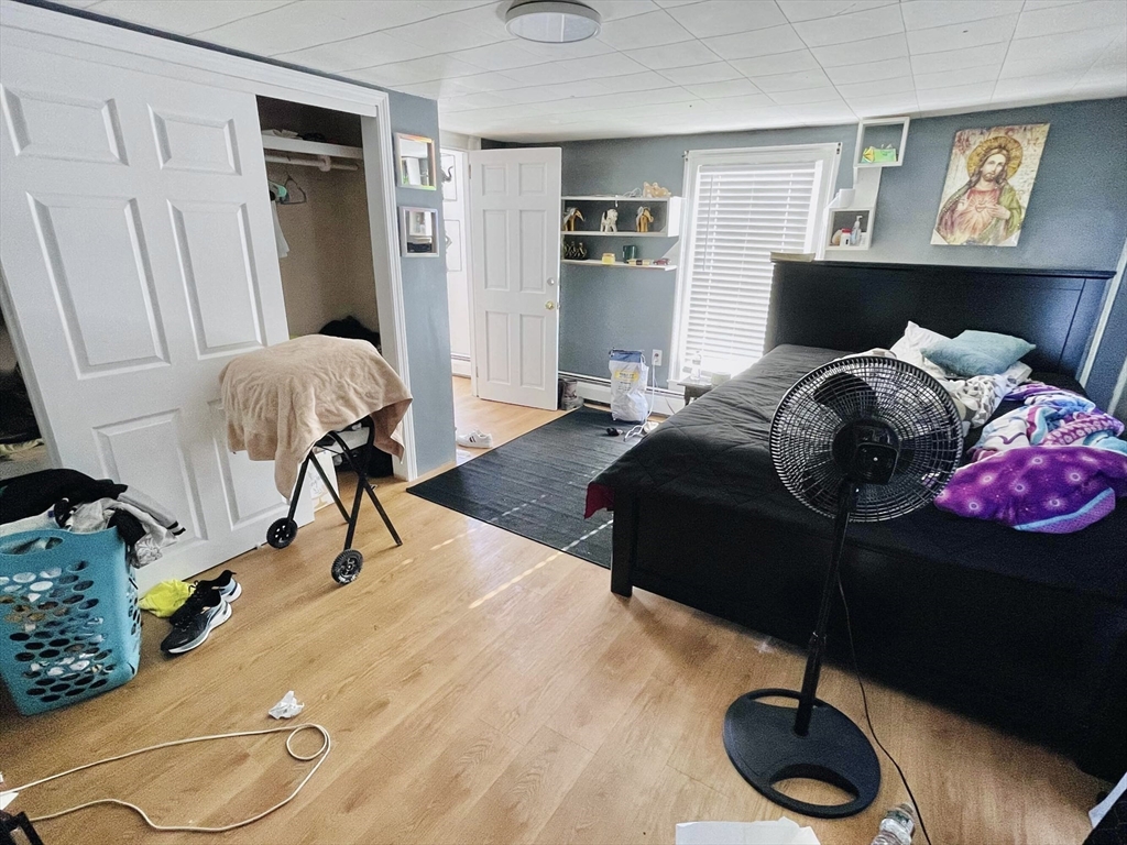 92 Mill Street Lancaster, MA 01523 - Photo 7 of 26 a bedroom with a bed and dresser with the potted plant