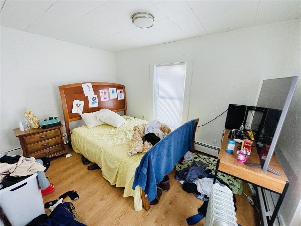 92 Mill Street Lancaster, MA 01523 - Photo 10 of 26 a bedroom with furniture and a flat screen tv