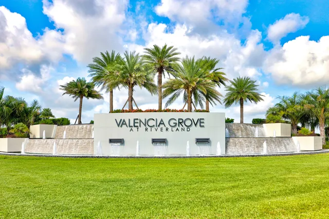 a view of a hallway with wooden floor and a bathroom