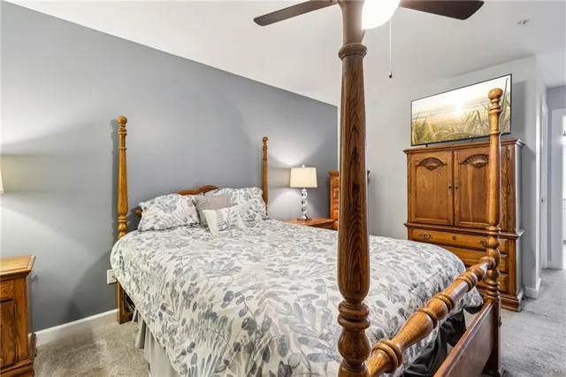 a bedroom with a bed and dresser with mirror