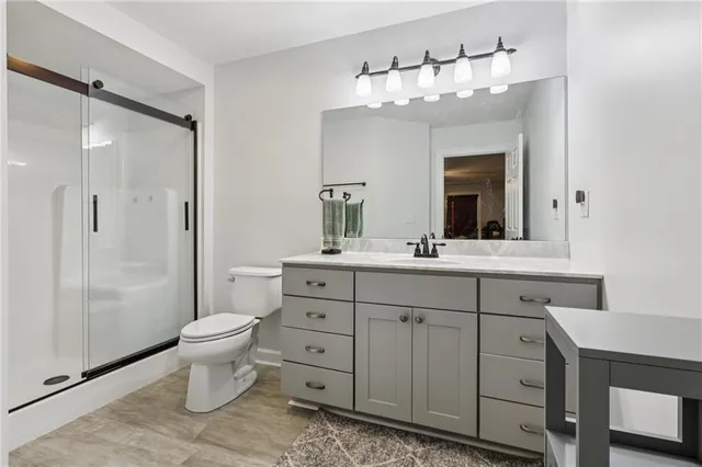 a bathroom with a toilet a sink and a mirror