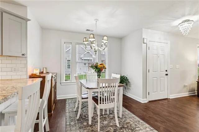 a view of a dining room with furniture and chandelier