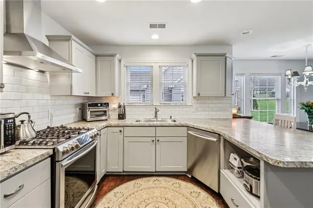 a kitchen that has a sink and a stove