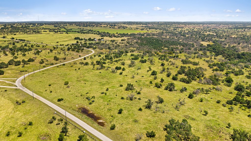 Tbd Reeh Road Fredericksburg, TX 78624 - Photo 8 of 37 Vast, open terrain featuring scattered trees and a winding road.
