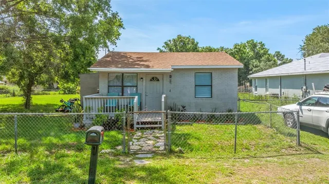 a view of house with backyard