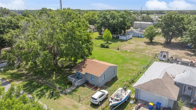 an aerial view of a house with garden space and street view