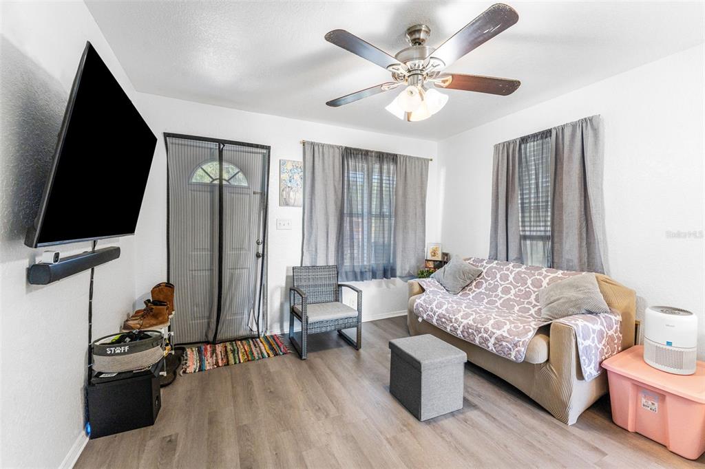 652 North Jackson Street Eagle Lake, FL 33839 - Photo 9 of 30 a living room with furniture and a flat screen tv