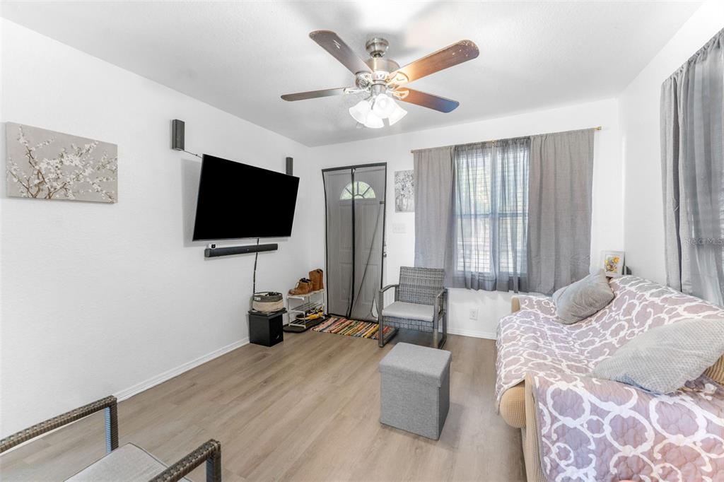 652 North Jackson Street Eagle Lake, FL 33839 - Photo 10 of 30 a living room with furniture and a flat screen tv