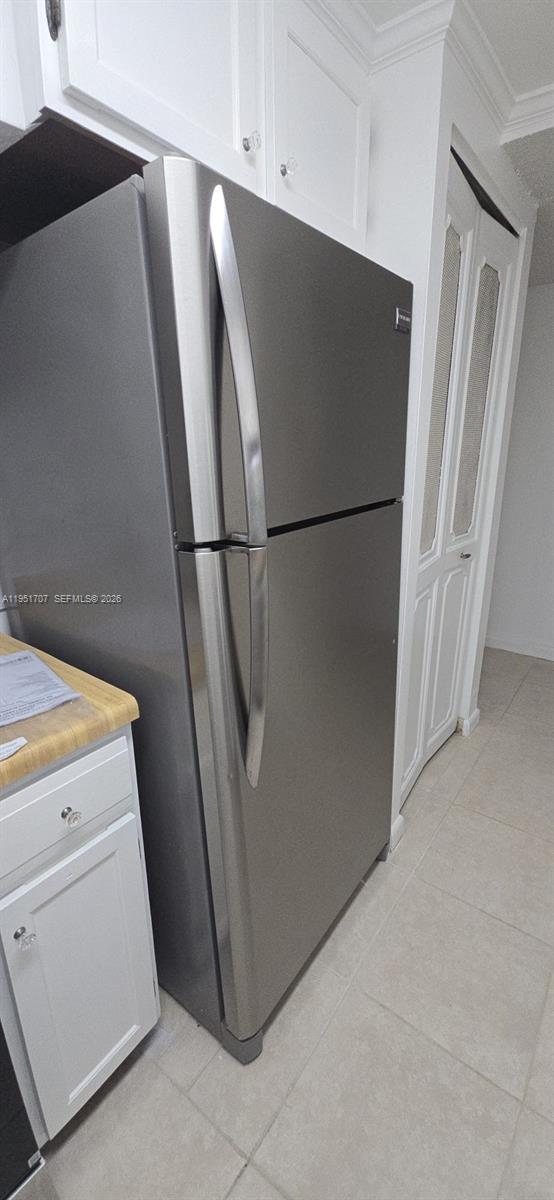 3680 Inverrary Drive, Unit 3M Lauderhill, FL 33319 - Photo 12 of 60 a white refrigerator freezer and a stove sitting inside of a kitchen