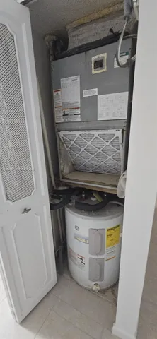 a bedroom with a bed and a refrigerator