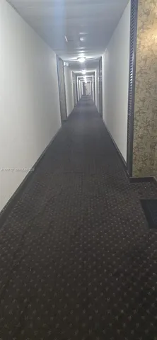 a view of water heater room with wooden floor