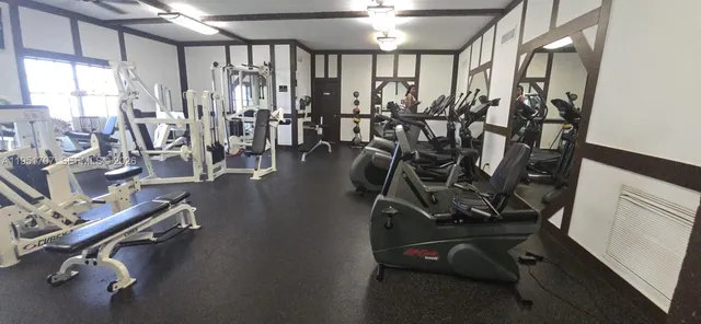 a living room with lots of furniture and a book shelf