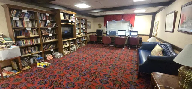 a view of a hallway with seating area