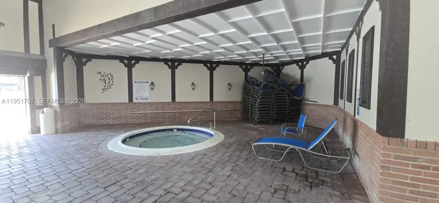 a view of a lake with a table and chairs next to a yard