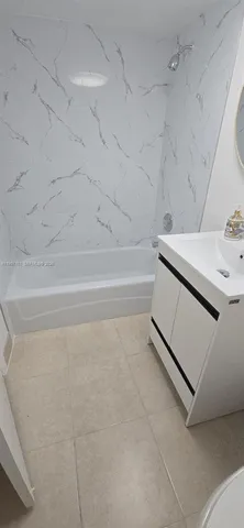 a bathroom with a sink and a bath tub