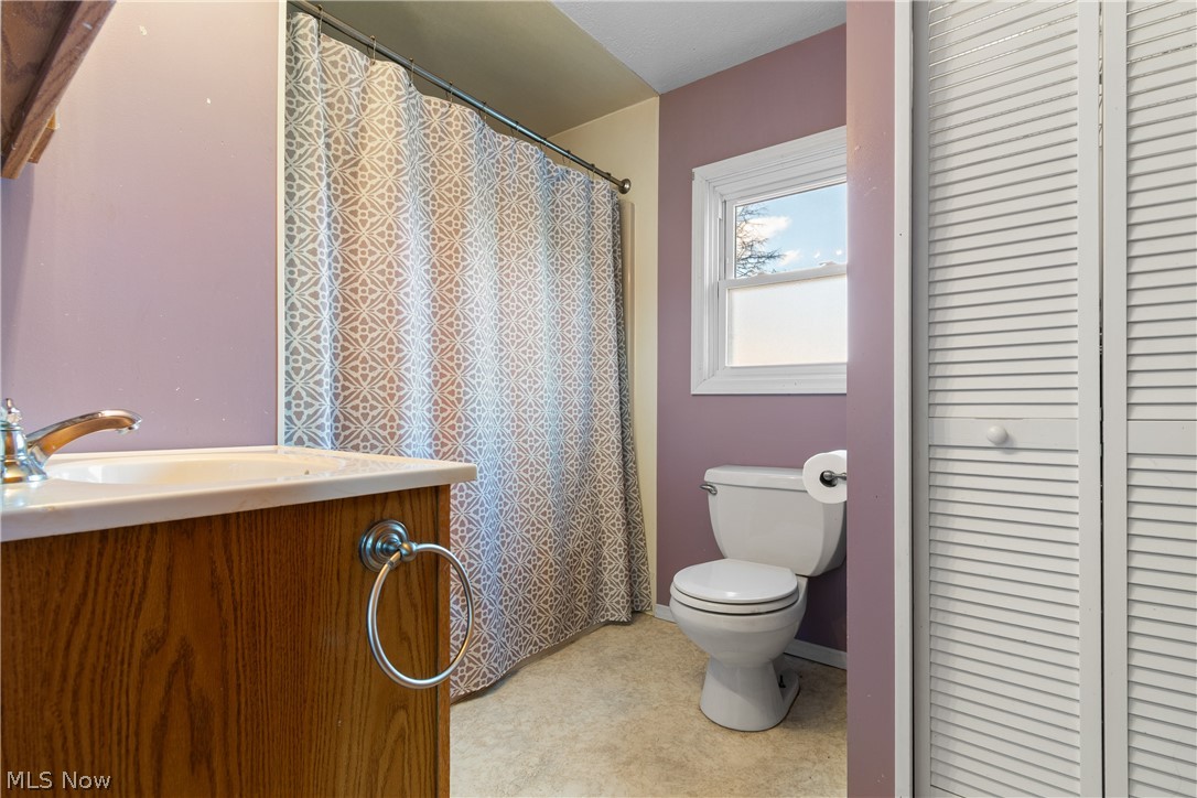 29395 Beitler Road Dennison, OH 44621 - Photo 7 of 33 Bathroom featuring a closet, a shower with shower curtain, vanity, and light floors