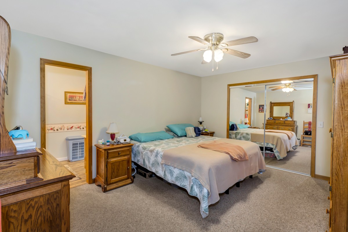 1997 Nancy Green Ridge Road Prospect, TN 38477 - Photo 12 of 25 a bedroom with a bed and a chandelier