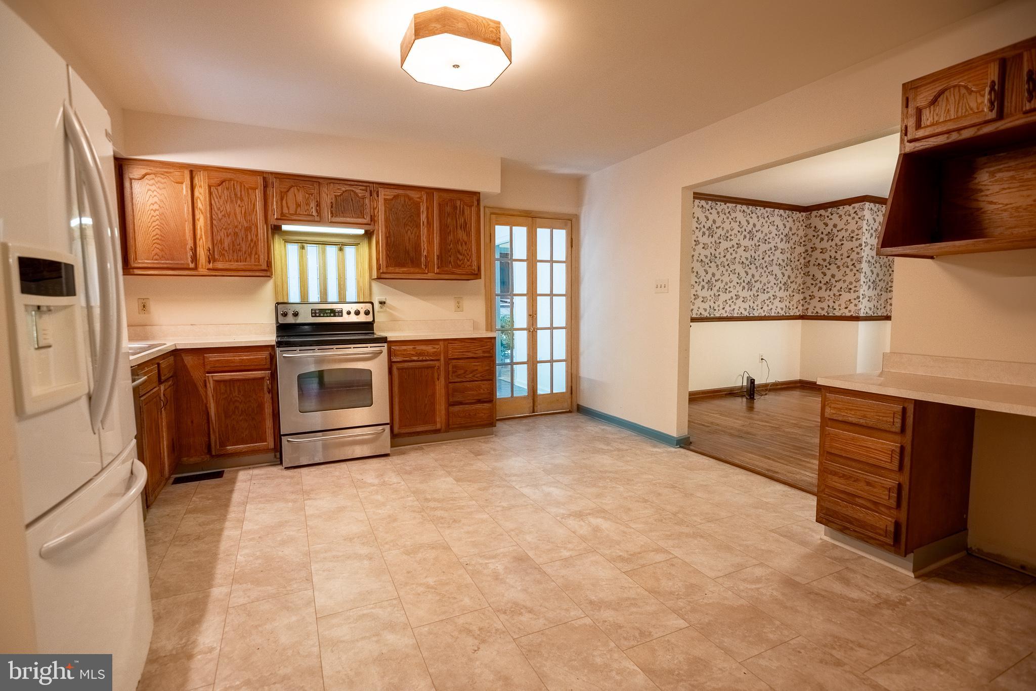 960 Bowie Shop Road Huntingtown, MD 20639 - Photo 60 of 69 a large kitchen with stainless steel appliances granite countertop a stove a sink and a microwave