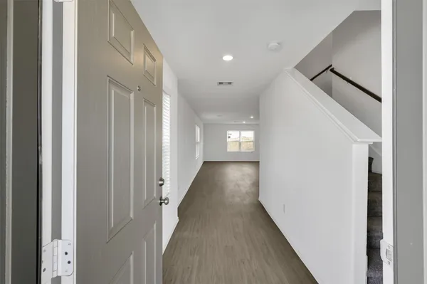 a view of a hallway with windows