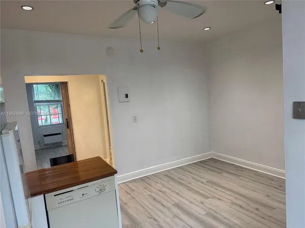 a room with a table and wooden floor