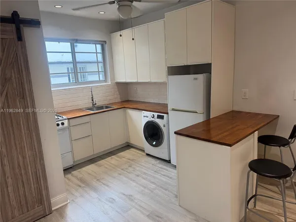 a kitchen with a sink a stove and cabinets
