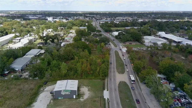 a view of a city with lush green forest