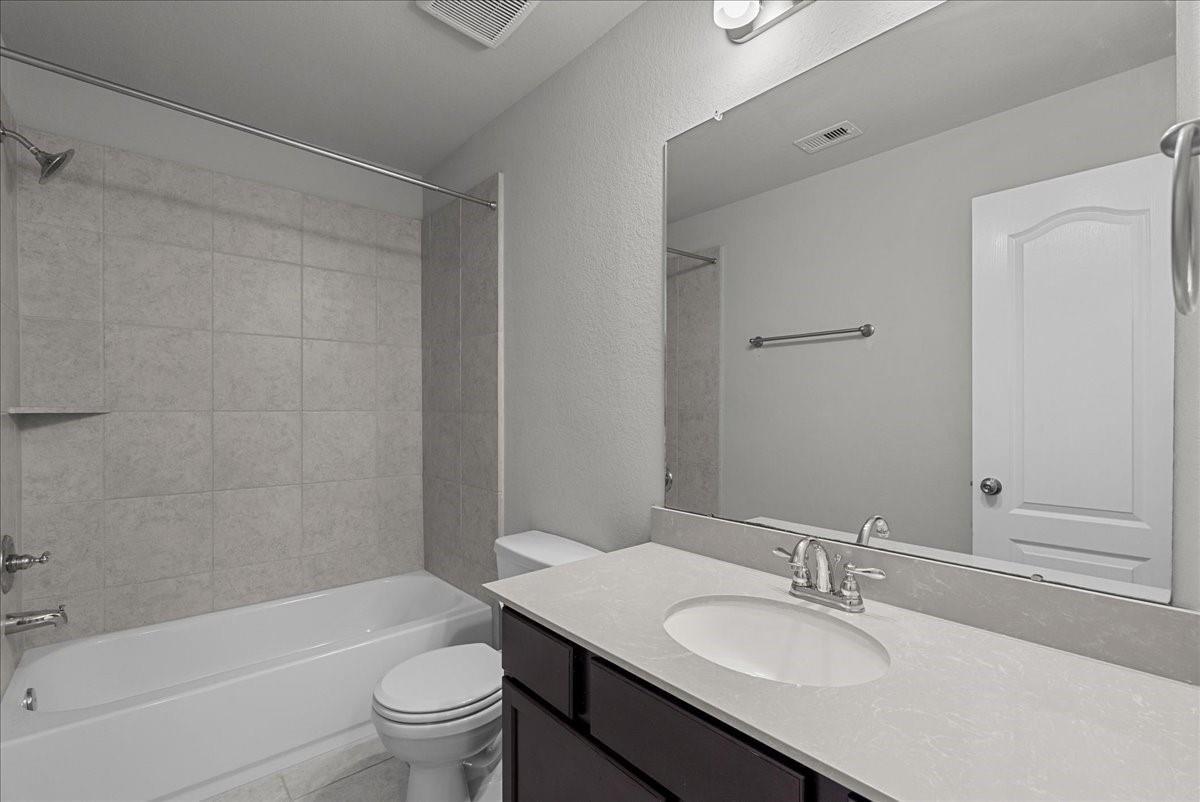 5111 Bay Lane Bacliff, TX 77518 - Photo 19 of 37 a bathroom with a granite countertop sink a toilet and shower