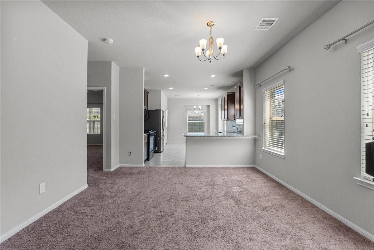 5111 Bay Lane Bacliff, TX 77518 - Photo 9 of 37 a view of a big room with windows and chandelier