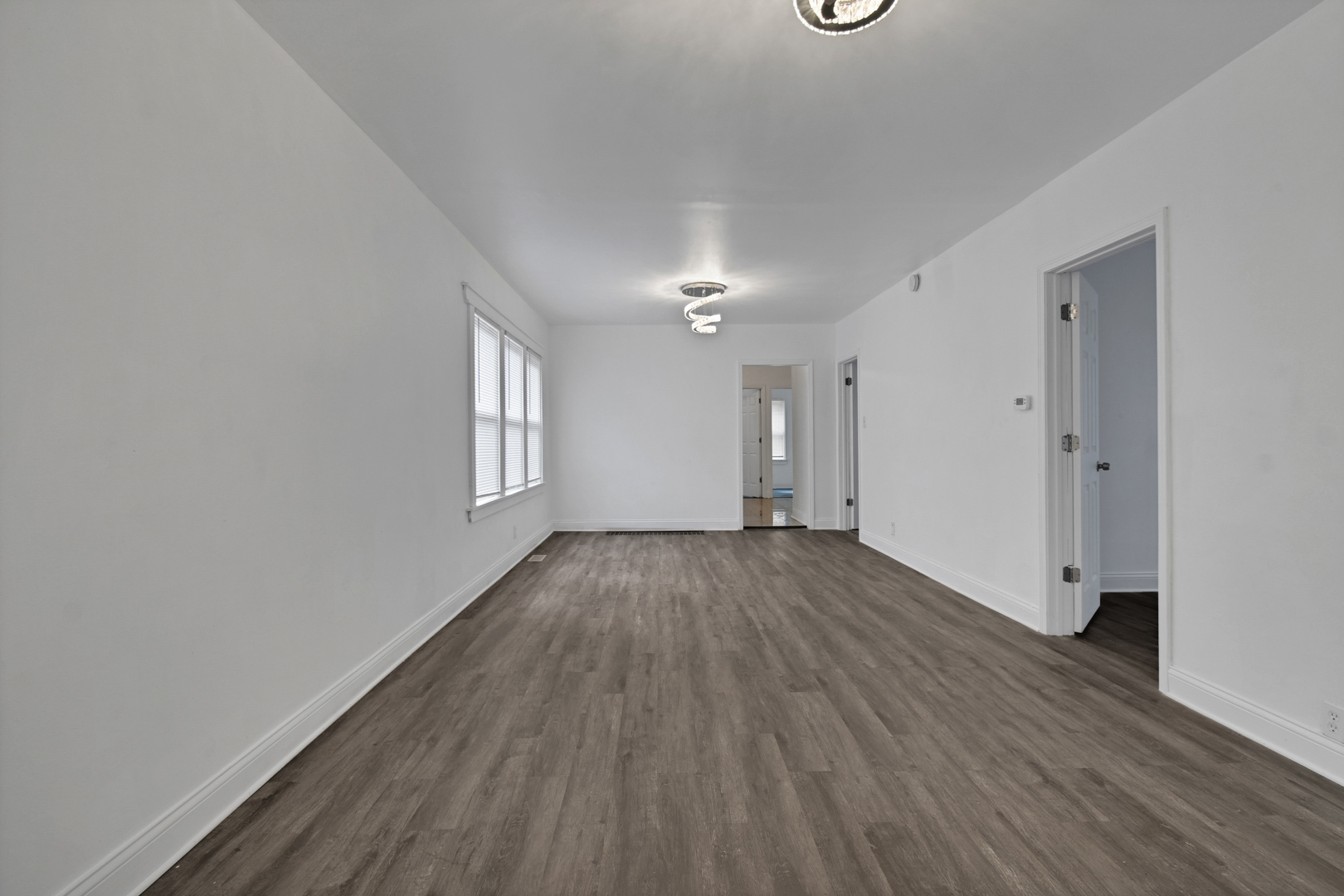 1011 West 103rd Place Chicago, IL 60643 - Photo 5 of 22 a view of a room with wooden floor and window
