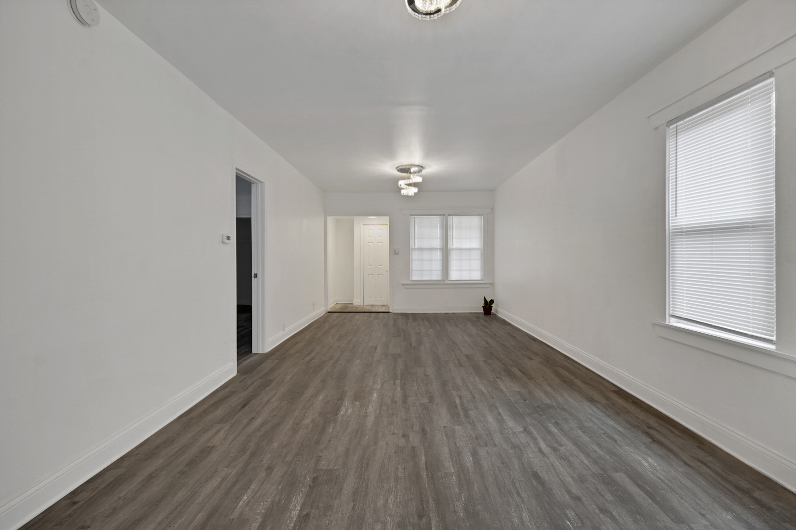 1011 West 103rd Place Chicago, IL 60643 - Photo 6 of 22 an empty room with wooden floor and windows