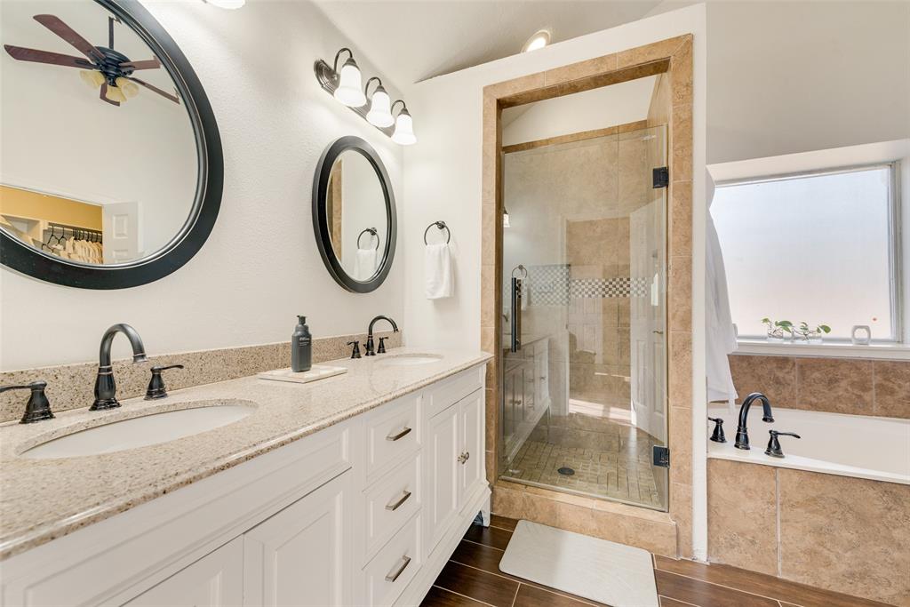 106 Villanova Circle Forney, TX 75126 - Photo 16 of 26 a bathroom with a double vanity sink mirror and shower