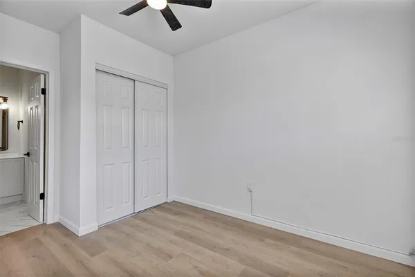 an empty room with ceiling fan