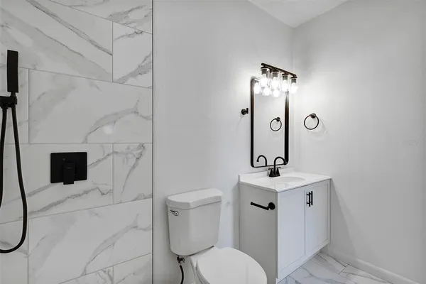a bathroom with a sink toilet and shower